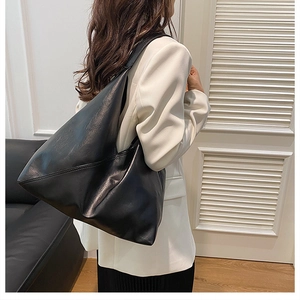 Close-up of high-quality soft black leather texture on a spacious hobo tote bag