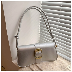 Detail of silver metallic shoulder bag with gold woven buckle and rope strap detail