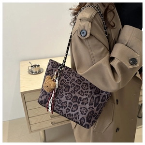 Chic leopard print tote bag with metal chain strap and cute bear plush charm accessory