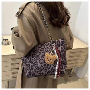 Leopard print tote bag with metal chain strap and cute plush bear charm detail