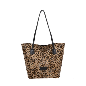 Fashionable leopard print tote bag with black slim straps for versatile shoulder or crossbody use