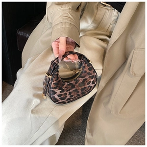 Detailed view of mini leopard print hobo bag with golden zipper and leather texture