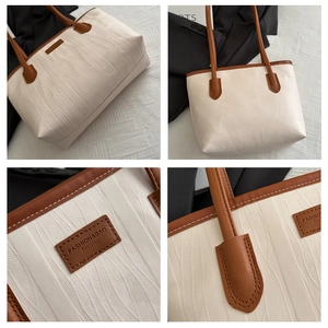 Close-up of beige tote bag featuring wave texture pattern and vintage brown leather handle