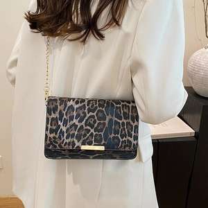 Chic leopard print rectangular shoulder bag with gold chain strap on a white blazer