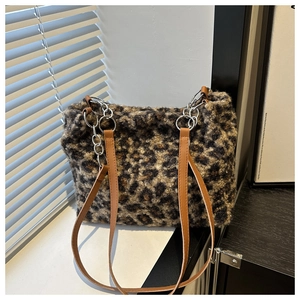 Detail of leopard print plush tote bag with faux fur texture and silver metal chain strap