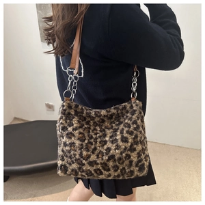 Detail of plush leopard print tote bag with leather and silver chain shoulder strap