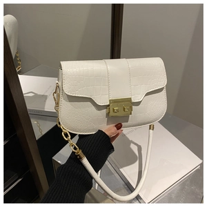 Detail of white croc-effect shoulder bag with gold metal buckle and chunky chain strap