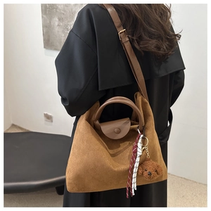 Grand sac fourre-tout en similicuir marron porté en bandoulière avec ours en peluche