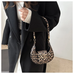 Detail of leopard print hobo bag with gold buckle on black coat style
