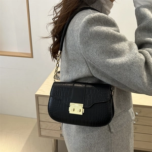 Minimalist black crocodile pattern square crossbody bag with gold chain strap detail