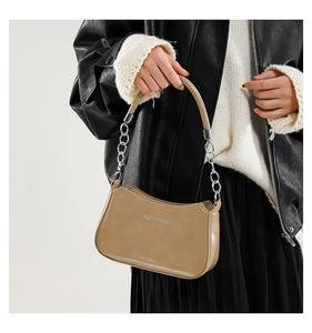 Detail of khaki crescent shoulder bag with silver chain strap and fashion text branding
