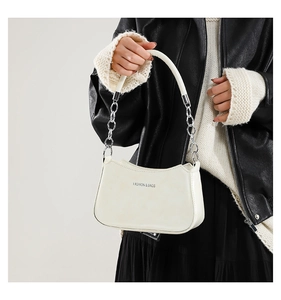 Close-up of cream white crescent bag with FASHION & BAGS print and silver chain handle