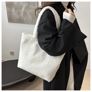 Detail of white plush faux fur tote bag showing soft texture and large capacity