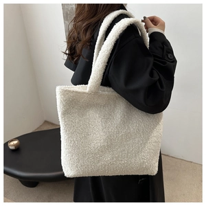 Detailed texture of white plush faux fur tote bag showing soft lamb wool material