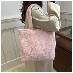Close-up of pink faux fur tote bag showing soft plush texture and large shoulder strap