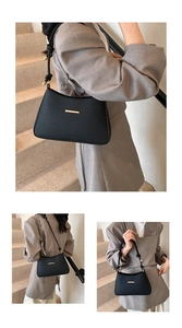 Detail of black matte leather shoulder bag with gold metal trim and woven handle strap