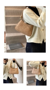 Detailed macro view of beige lace embossed pattern and knot shoulder strap on the handbag