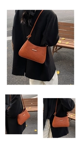 Detail of caramel shoulder bag with floral embossing and silver bar on autumn model