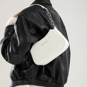 Minimalist white leather crescent shoulder bag with silver chain strap and fashion logo
