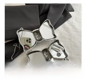 Detail view of silver bow-shaped acrylic metal mini bag with chain and inner mirror