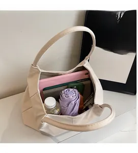 Interior view of beige tote bag showing spacious storage for a tablet, umbrella, and phone