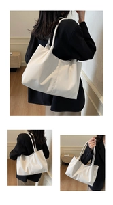 Close-up of minimalist white PU leather tote bag with soft texture and slim shoulder straps