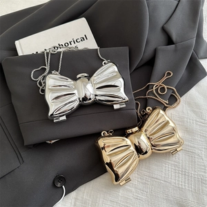 Mini bow-shaped acrylic evening clutch bag with glossy metallic finish and chain strap