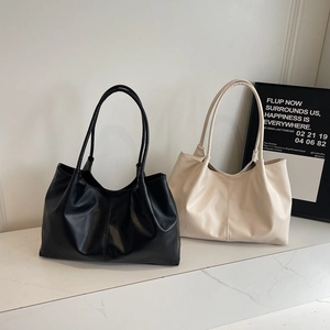 Women's pleated faux leather tote bags in black and cream beige with long shoulder straps