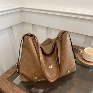 Brown leather tote bag with butterfly metal accents and pleated vintage design