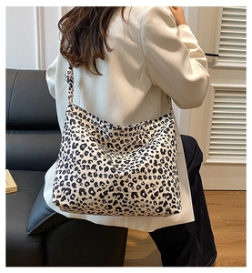Rear view of a model wearing the large leopard print canvas tote bag for styling size
