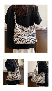 Detail of large leopard print tote bag showing canvas texture and wide shoulder strap