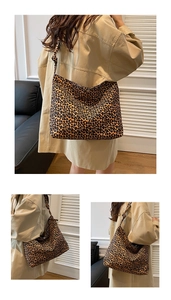 Detailed view of a large leopard print tote bag with soft suede texture and sturdy strap