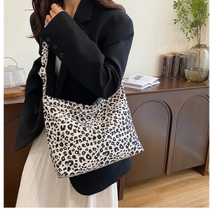 Detailed view of the large leopard print canvas tote bag styled with a professional outfit