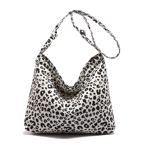 Chic black and white leopard print hobo tote bag with wide strap for casual wear