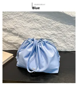 Detailed close-up of light blue drawstring handbag with elegant silver bow decoration