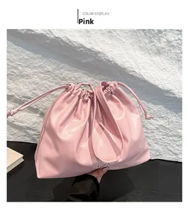 Detail of the pink drawstring cloud bag showing soft pleated texture and knotted cord