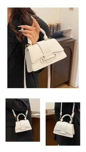 Detail of white litchi pattern mini handbag with gold ring buckle and shoulder strap