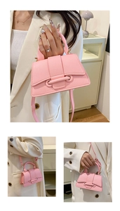 Detail of pink lychee textured PU leather mini square bag with top handle and strap