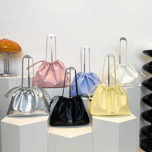 Large drawstring bucket bags in various colors with metallic bow details and chic slouchy style