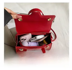 Top view of red crocodile-patterned handbag showing spacious interior and compartments
