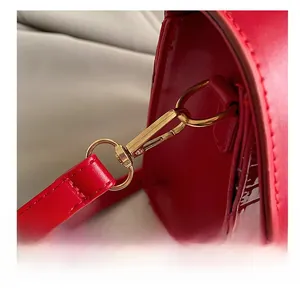 Close-up of red crocodile embossed leather with premium gold metal hook details