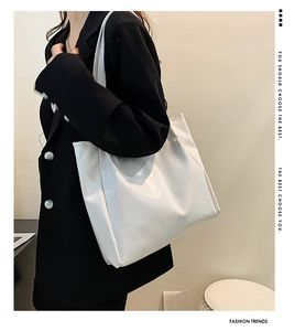 White minimalist large tote bag styled with a black blazer for a professional look