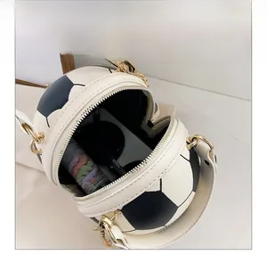 Internal view of a football-shaped crossbody bag showing capacity for phone and cosmetics