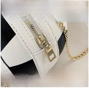 Detail of smooth golden zipper and lychee texture leather on basketball shaped bag