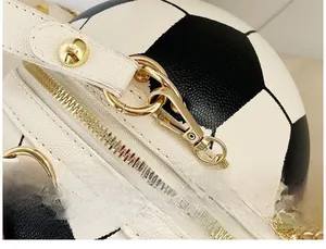 Close-up of football-shaped crossbody bag featuring lychee texture and gold-tone hardware