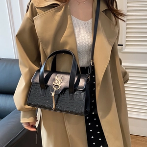 Elegant black two-tone handbag with crocodile pattern base and gold S-shaped buckle