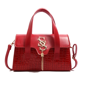 Elegant red leather handbag with crocodile pattern finish and gold tassel hardware