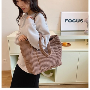 Detailed texture of a brown corduroy tote bag showing large capacity for daily commuting