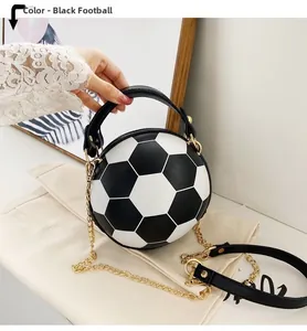Detailed close-up of a black and white soccer-shaped handbag with a gold chain strap