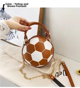Detail of yellow-brown soccer-shaped handbag with leather texture and gold chain strap